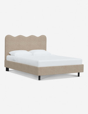 Angled view of Clementine buff boucle platform bed with undulating lined headboard