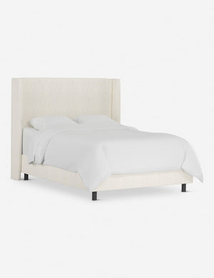 Angled view of the Adara talc linen upholstered bed.