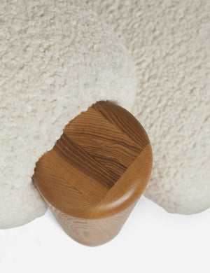 Bird's-eye view of the wooden leg on the top of the James faux sherpa accent chair