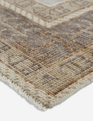 Angled close-up of the corner of the Kate desert palette geometric floor rug