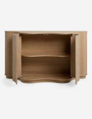 Cora half-moon, wavy light-wood sideboard with doors open