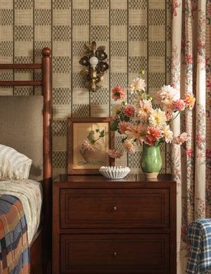 Garda ornate floral metalwork wall sconce by Heidi Caillier hung above a nightstand