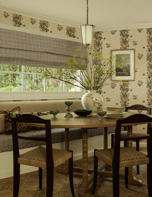 Frederick tapered glass shade chain pendant light by Heidi Caillier hung over a dining table