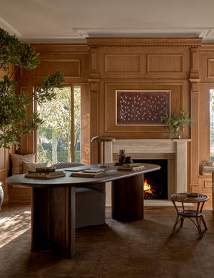 The Chiltern copper rug lays in an office space with wooden accented walls under a dark wooden desk