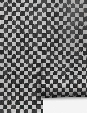 Checkerboard Wallpaper by Sarah Sherman Samuel for Lulu and Georgia Stage features irregular black squares on a light gray background, offering a modern, hand-drawn checkerboard look inspired by the designers collaboration.