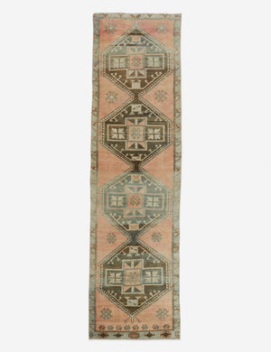 Vintage Turkish Runner Rug No. 31, measuring 28 x 1012, features geometric diamond patterns in muted pink, teal, and beige with intricate floral motifs along the border—a unique vintage centerpiece for your space.