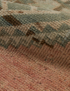 Close-up of Vintage Turkish Runner Rug No. 31 (28 x 1012), featuring a textured geometric pattern in soft pink, beige, green, and brown tones. The surface appears soft and raised, showcasing the intricate woven design of vintage wool rugs.