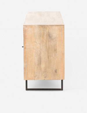 Side view of the Hannah natural mango wood sideboard with cane doors and an iron base.