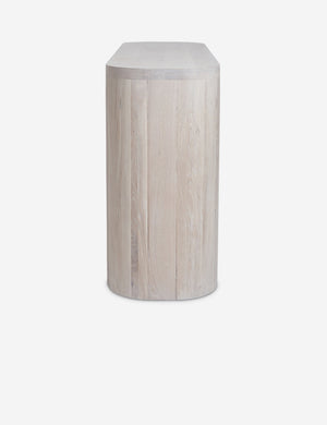 Side view of the Luna white-washed oak oval console table.