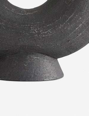 Close-up of the base of the Damien half-circle sculpture vase by Ateriors with matte black glaze finish