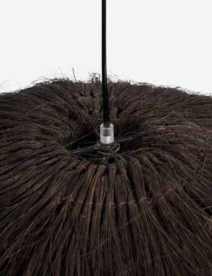 Close-up of the top of the Paige black plush pendant light with palm tree fibers