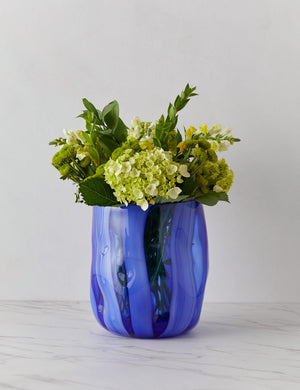 Umi glass vase with striated wave-like vertical blue lines with flowers inside