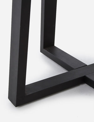 Close-up of the base on the Agatha indoor and outdoor dining table with lavastone top and black iron base