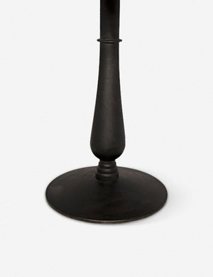 Close-up of the sculptural cast iron base on the Auriel side table with marble table top