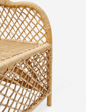 Close-up of the woven rattan on the seat and base of the Charley rattan accent chair with sloping back