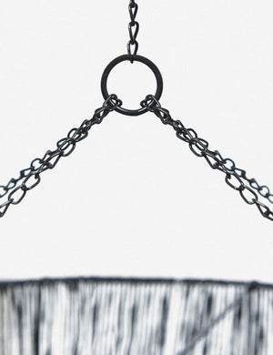 Close-up of the chained hanging attachment on the Chavette three-tiered black jute-wrapped chandelier