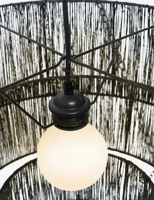 Close-up of the light fixture on the Chavette three-tiered black jute-wrapped chandelier