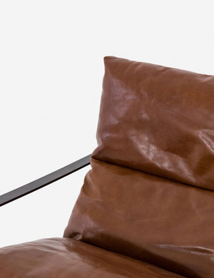 Close-up of the leather for the brown leather Marlyne sling-back accent chair with black metal frame