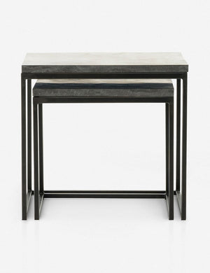 View of the Ginette bluestone nesting side tables with black metal legs with the smaller table fully nested under the larger table