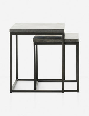View of Ginette bluestone nesting side tables with black metal legs with the smaller table half way under the larger table