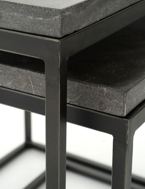Close-up of the corners of the Ginette bluestone nesting side tables with black metal legs