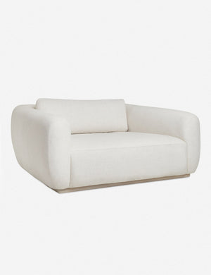 Angled left view of the Harlowe ivory oversized media lounger chair with acacia wood base