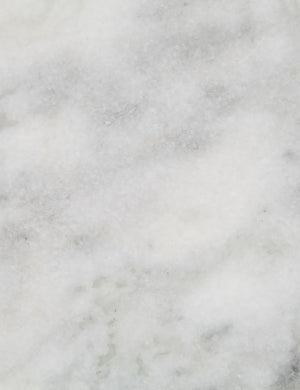 Detailed view of the white marble top on the Gianea side table with geometric top and black metal frame