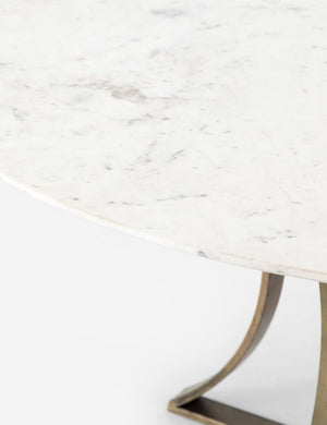 Close-up of the left side of the Brea round dining table with marble top and gold base