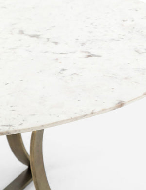 Close-up of the right side of the Brea round dining table with marble top and gold base