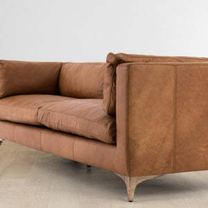 Angled side view of the Jocelyn brown leather sofa
