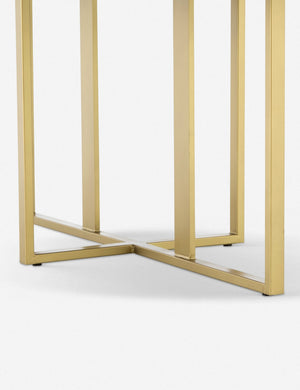 Close-up of the brass legs on the Kara oval dining table with white marble top