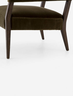 Close-up of the deek oak legs and bottom olive velvet cushioning on the Lyssa olive velvet accent chair