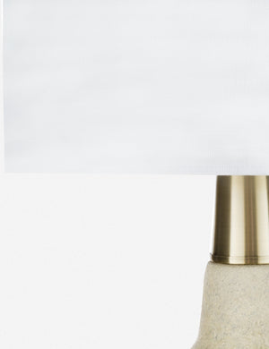 Close-up of the gold accenting between the base and finial on the Langley table lamp with stone base and white finial