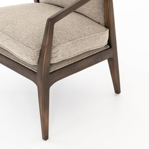 Close-up of the right side of the Rhea accent chair with natural-toned cushions and curved wicker back