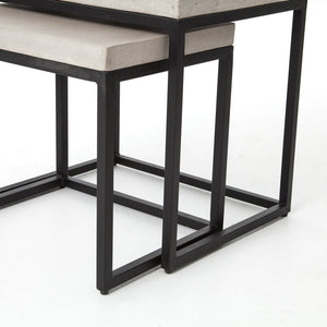 Close-up of the Kallia indoor and outdoor nesting side tables with iron bases and concrete tops with the smaller table half nested into the bigger table